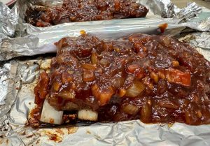 Ribs roasted with diced onion for extra juiciness