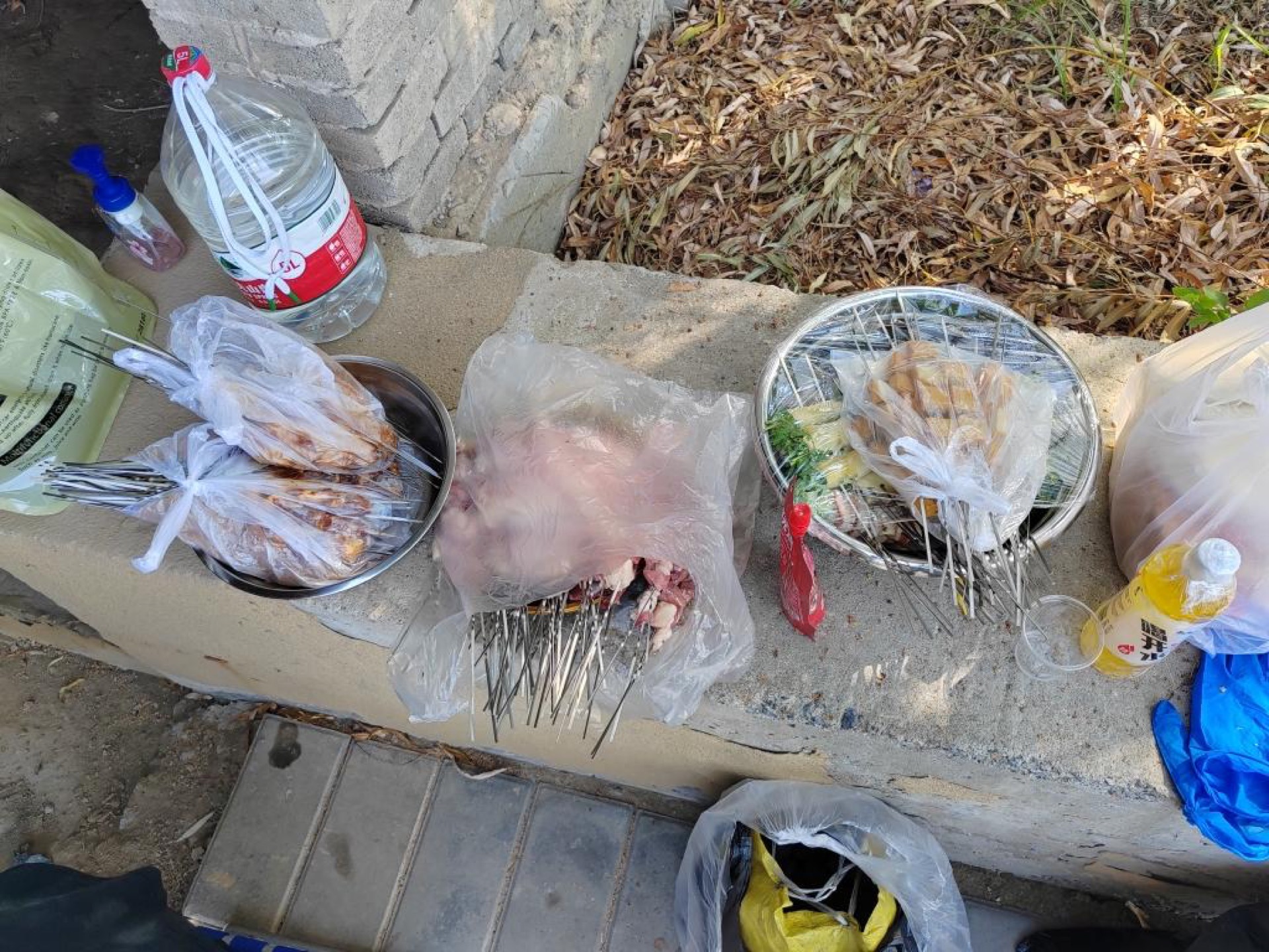 Grill heated and ready with raw skewers nearby