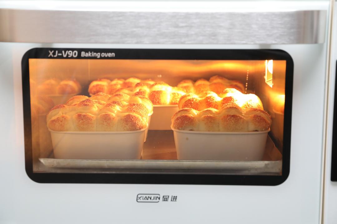 Baking the filled rolls in a preheated oven until deep golden