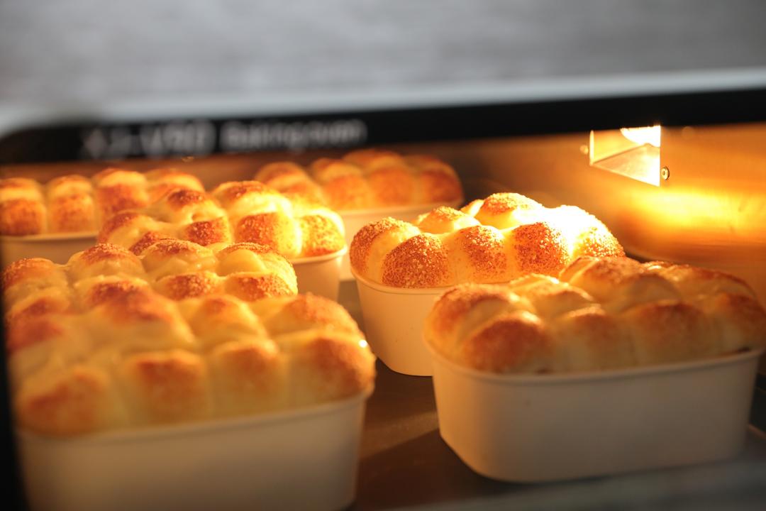 Checking the baked rolls for color inside the bento molds