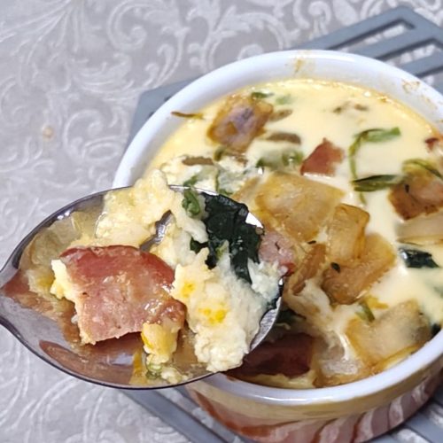 Baked pumpkin spinach cheese custard sliced into wedges in a parchment-lined mold