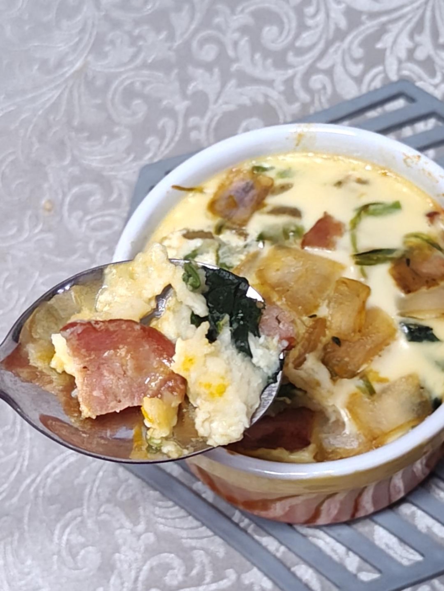 Baked pumpkin spinach cheese custard sliced into wedges in a parchment-lined mold