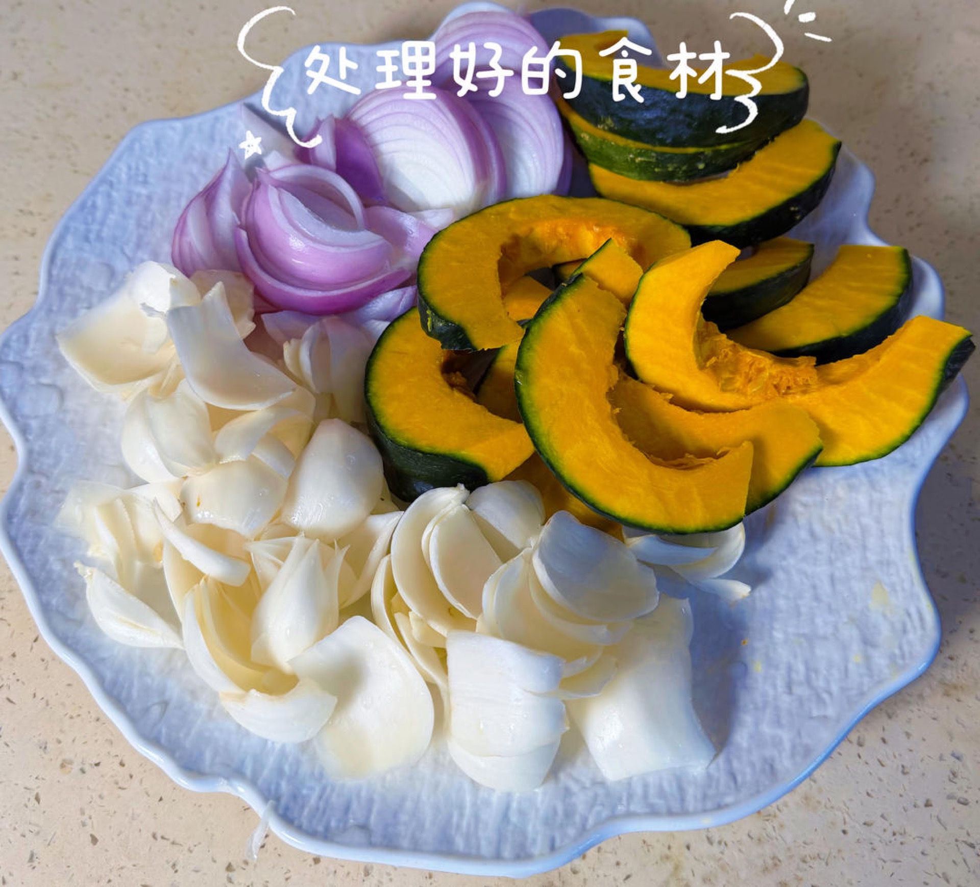Arrange all the prepared ingredients on a board: kabocha wedges, separated lily petals, sliced onion, and the mixed sauce so everything is within reach before the pot goes on the h