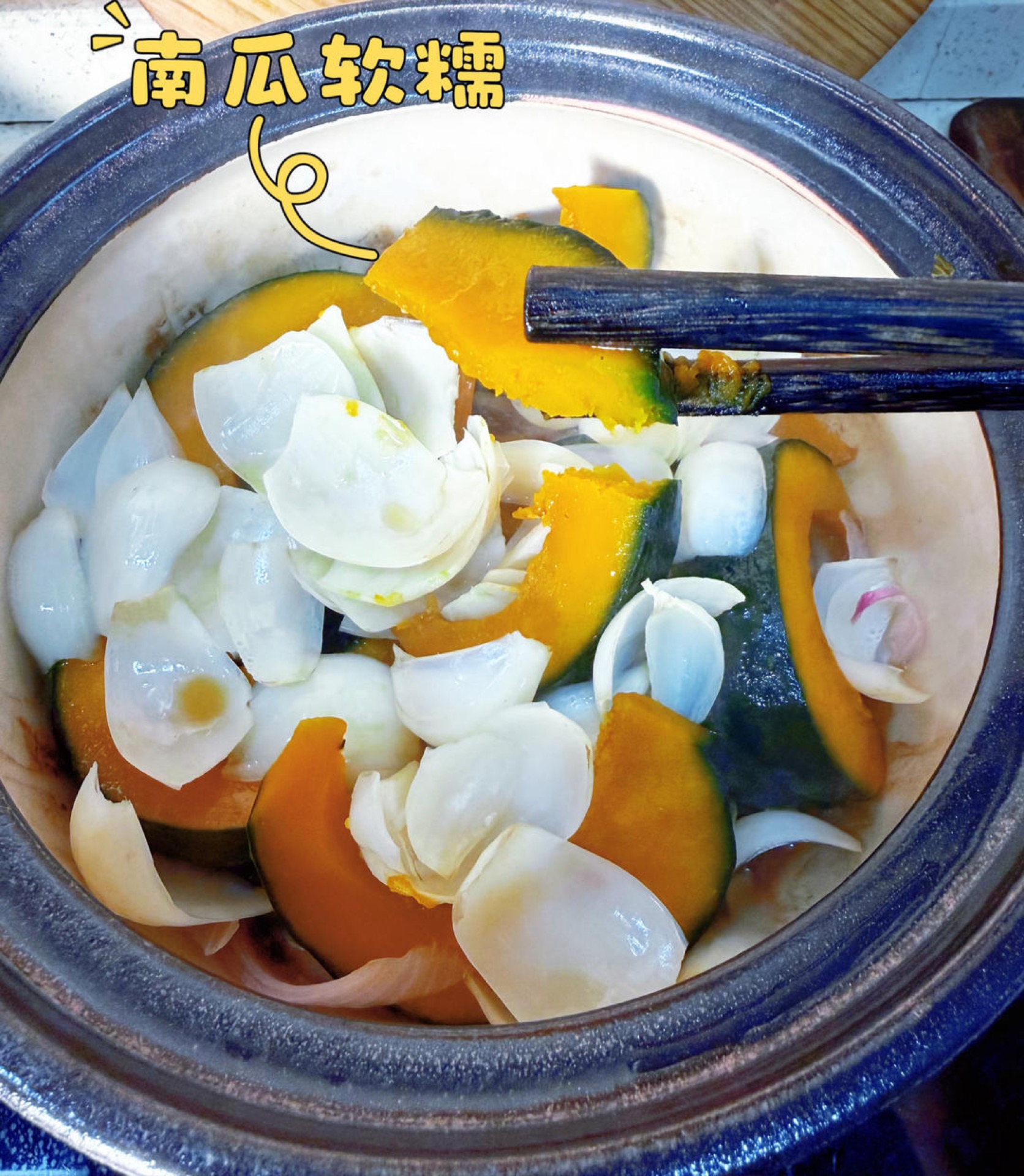 Uncover, spoon the glaze over the pumpkin and lily, scatter the scallion over the top, and serve hot straight from the pot.