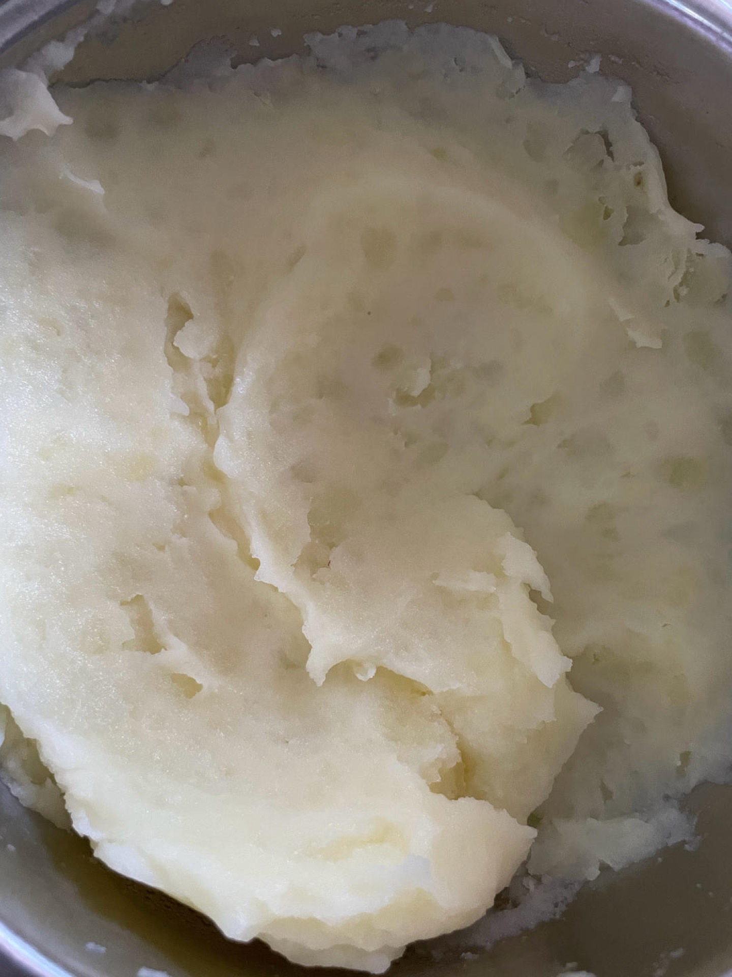 Mash the steamed potatoes into a fine, smooth mash with no lumps.