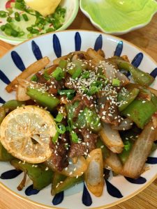 Finished glossy beef tenderloin stir fry on a serving plate