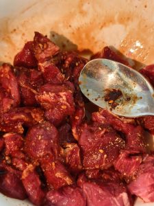 Marinating the beef slices in the seasoned mixture