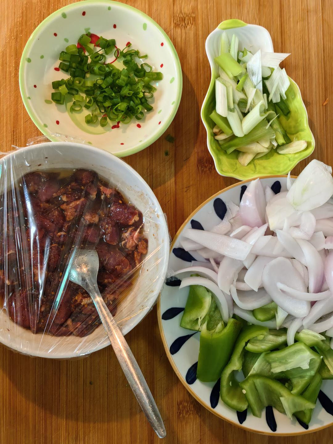 Slicing green pepper onion and aromatics for the stir fry
