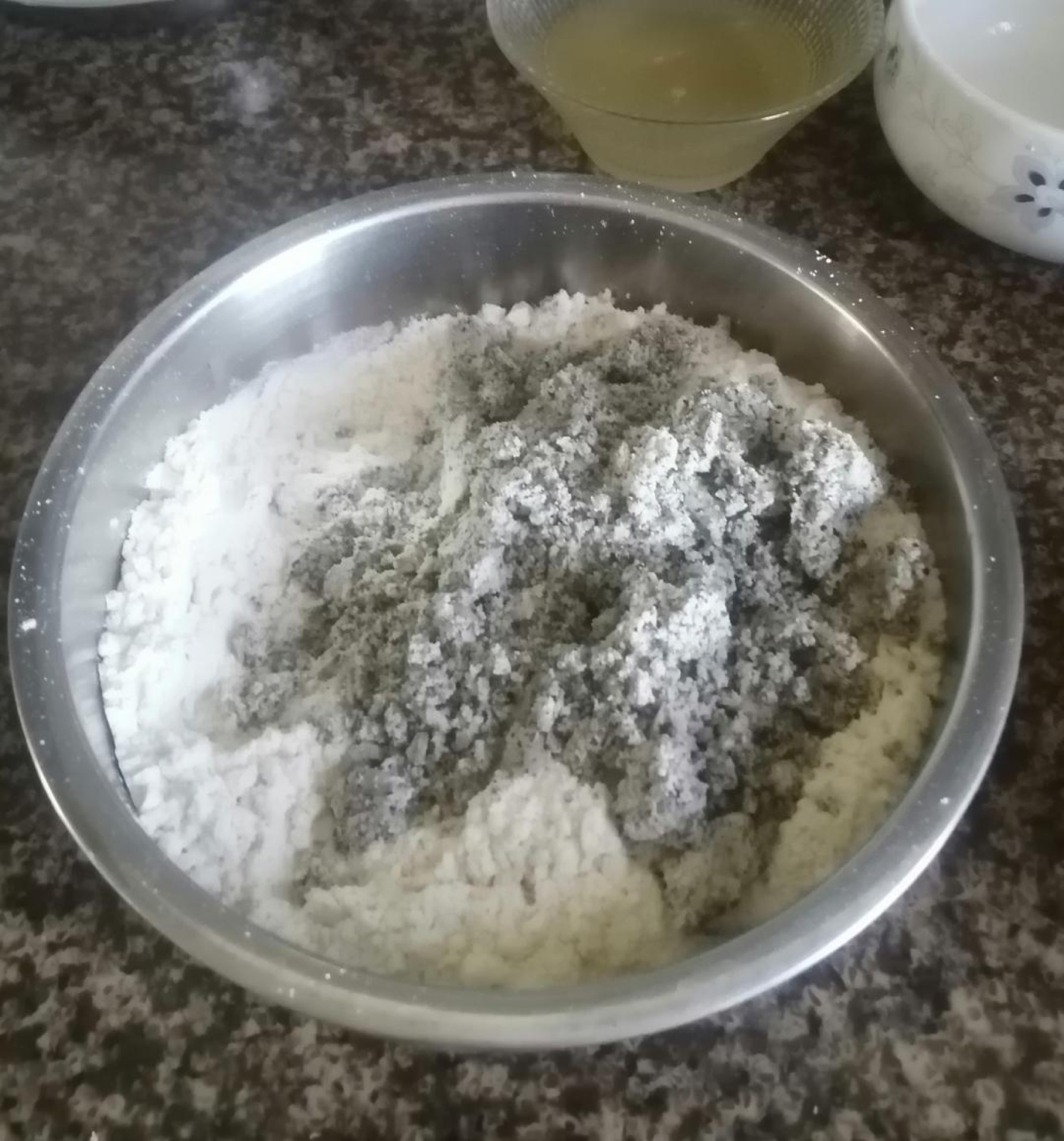In a large bowl, combine the flour, squeezed-dry black bean dregs, yeast, sugar, and water, stirring until a shaggy dough forms.