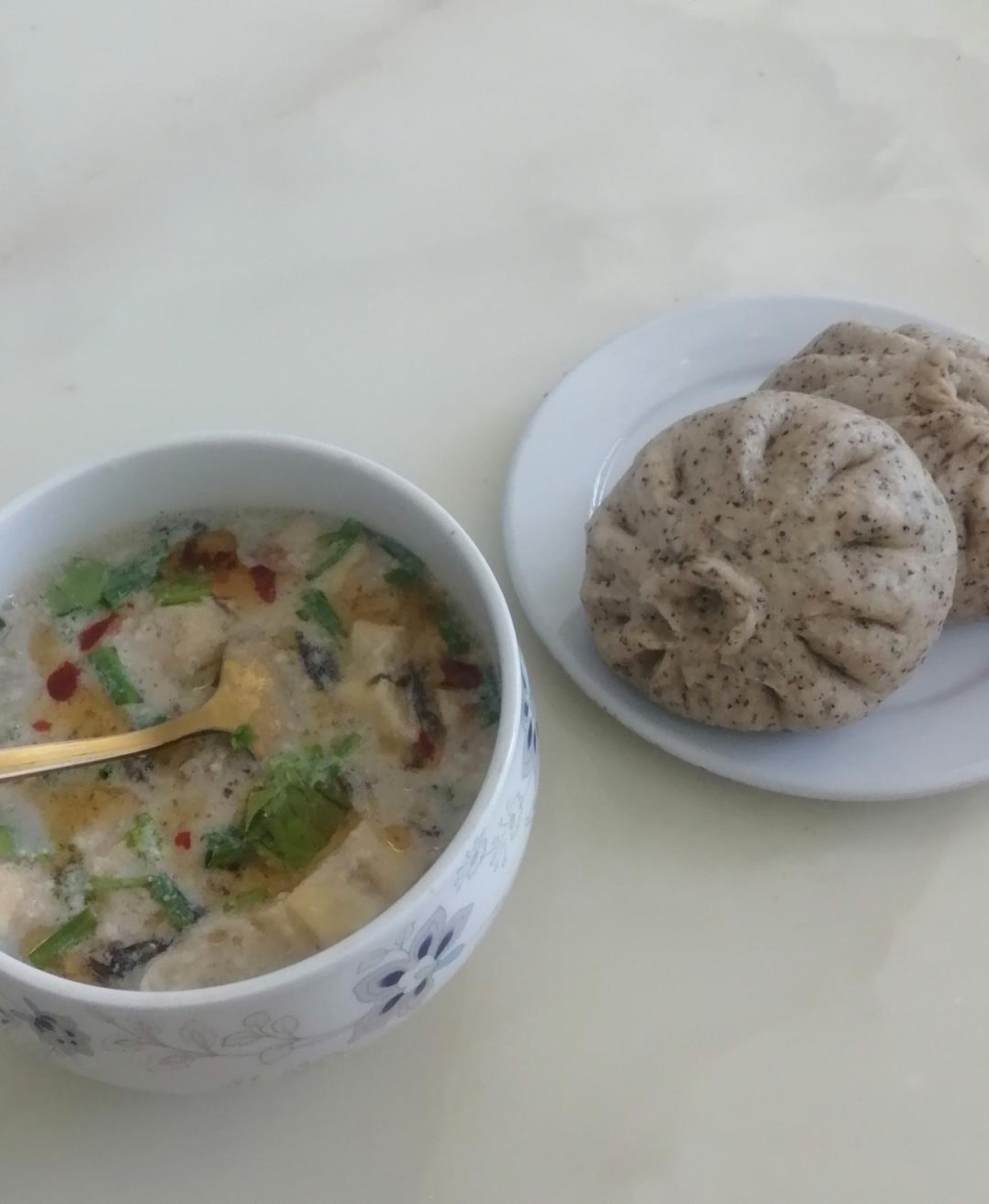 Serve the black bean dregs pork buns hot alongside a cup of savory black soy milk.