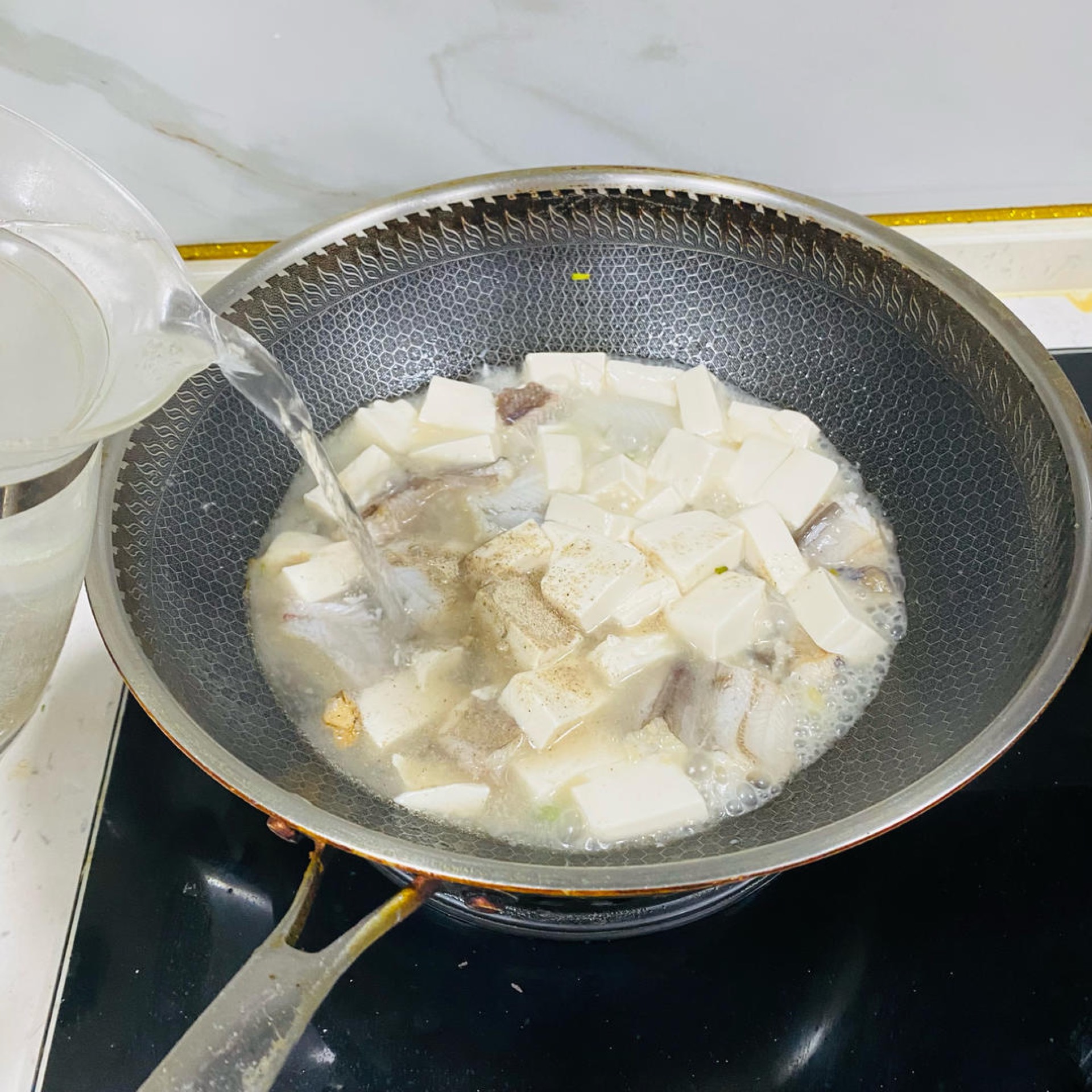 Pour in enough boiling water to cover the ingredients.