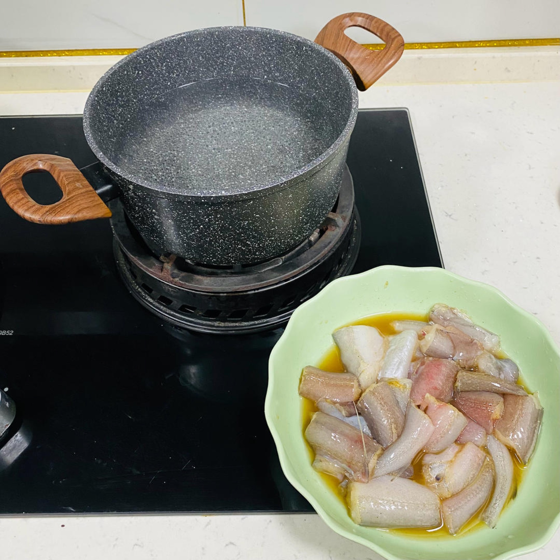 Bring a pot of water to a boil and slide in the Bombay duck segments.