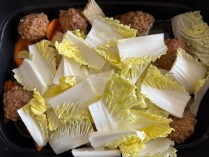 Add the cabbage stems, cover with the lid, and let them steam and soften for a few minutes.