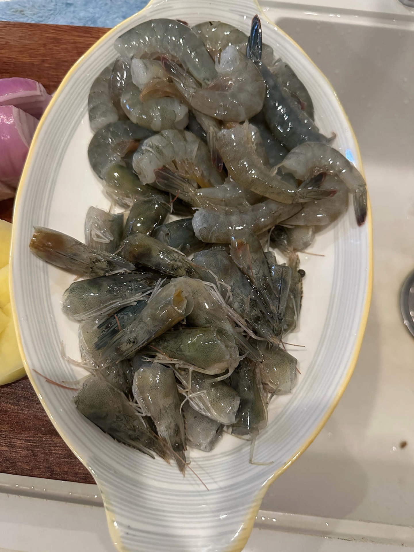 Separate the shrimp heads from the shrimp bodies and set both aside.