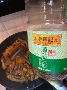 Pour in boiling water to cover the ingredients, then add three tablespoons of light soy sauce.