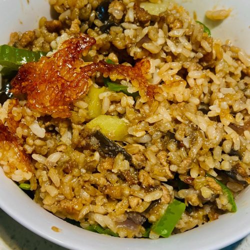 Braised eggplant and minced pork rice in a pot with a crispy golden rice crust on the bottom