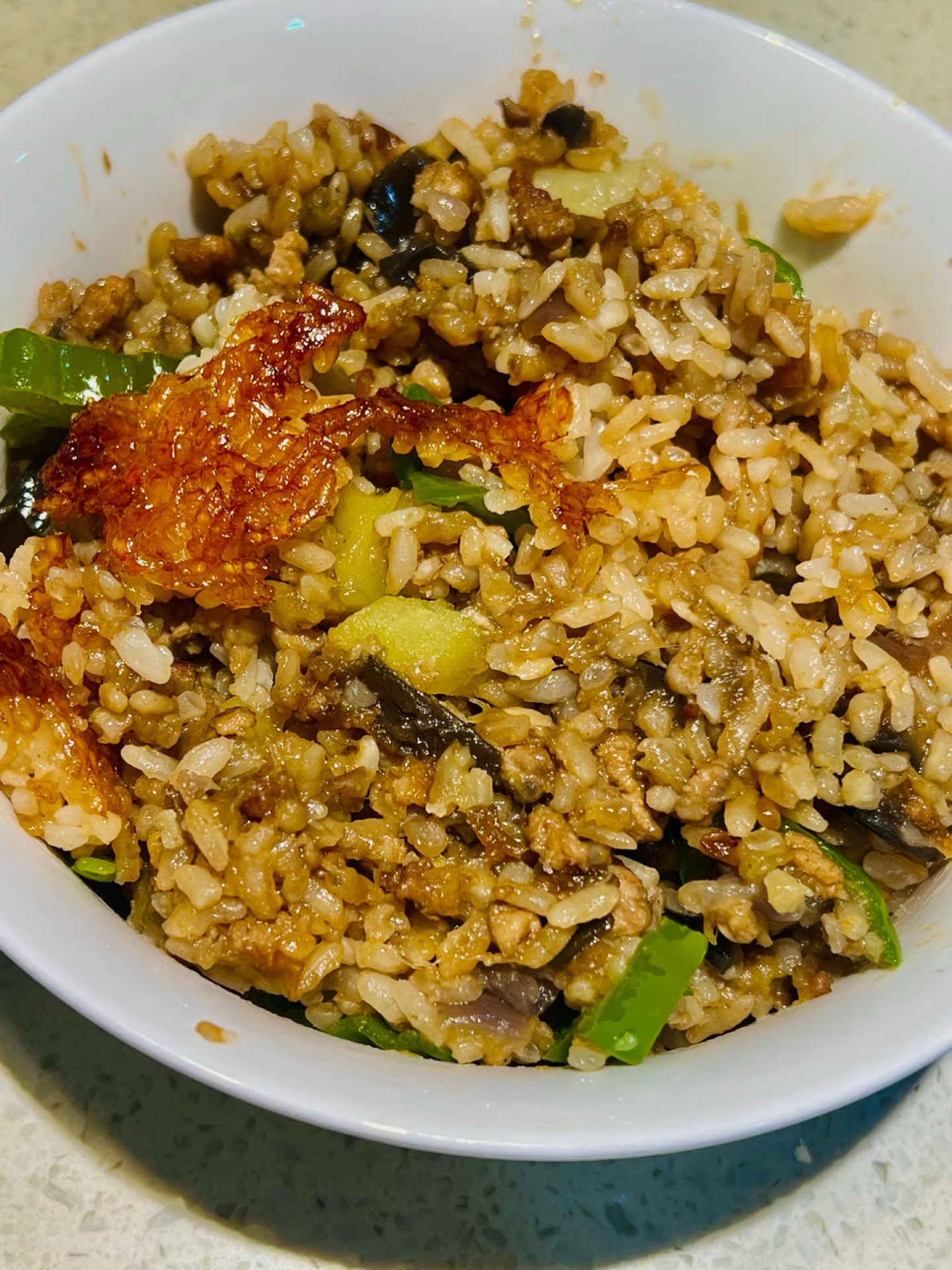 Braised eggplant and minced pork rice in a pot with a crispy golden rice crust on the bottom