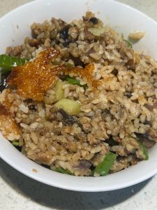 Scoop out the eggplant braised rice with its crispy bottom crust and serve.