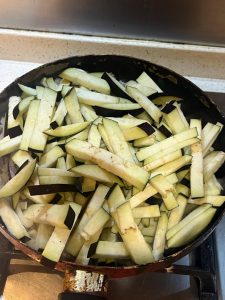Add the eggplant strips to the wok.