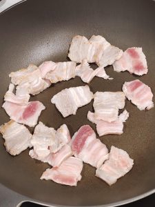 Heat the wok and fry the pork belly until it is fragrant and has released its fat.