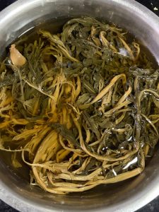 Dried mustard greens soaking in warm water