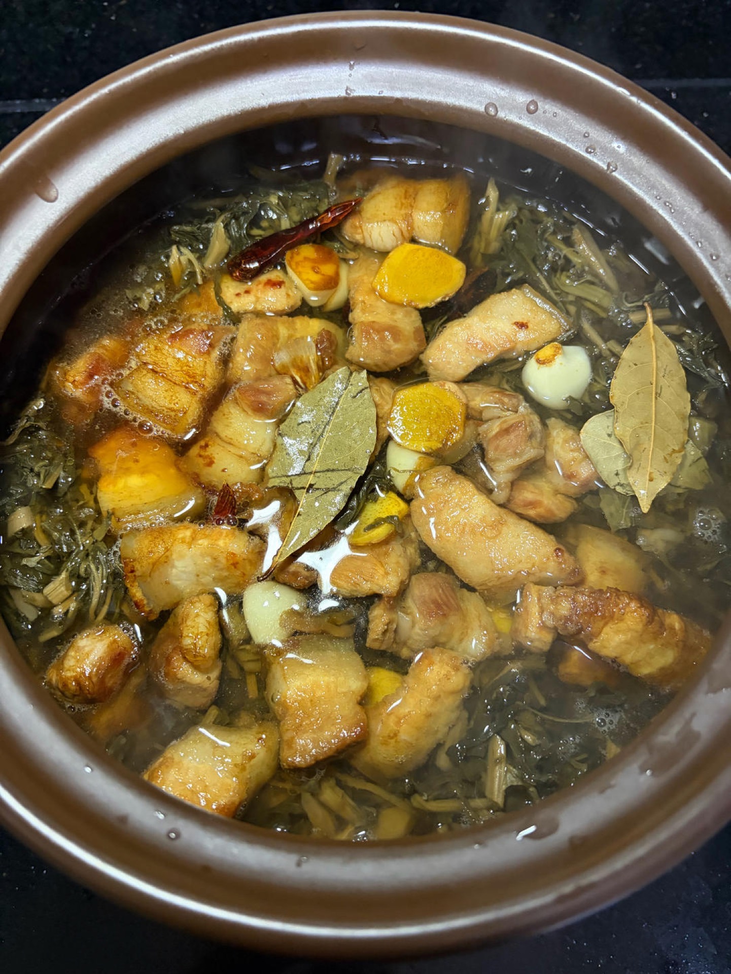 Braising liquid added to the clay pot