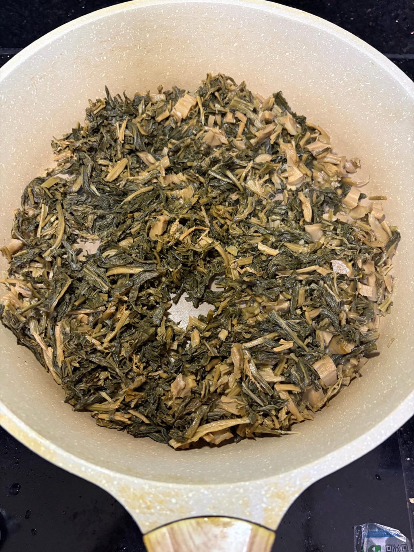 Toasting dried greens in a dry wok