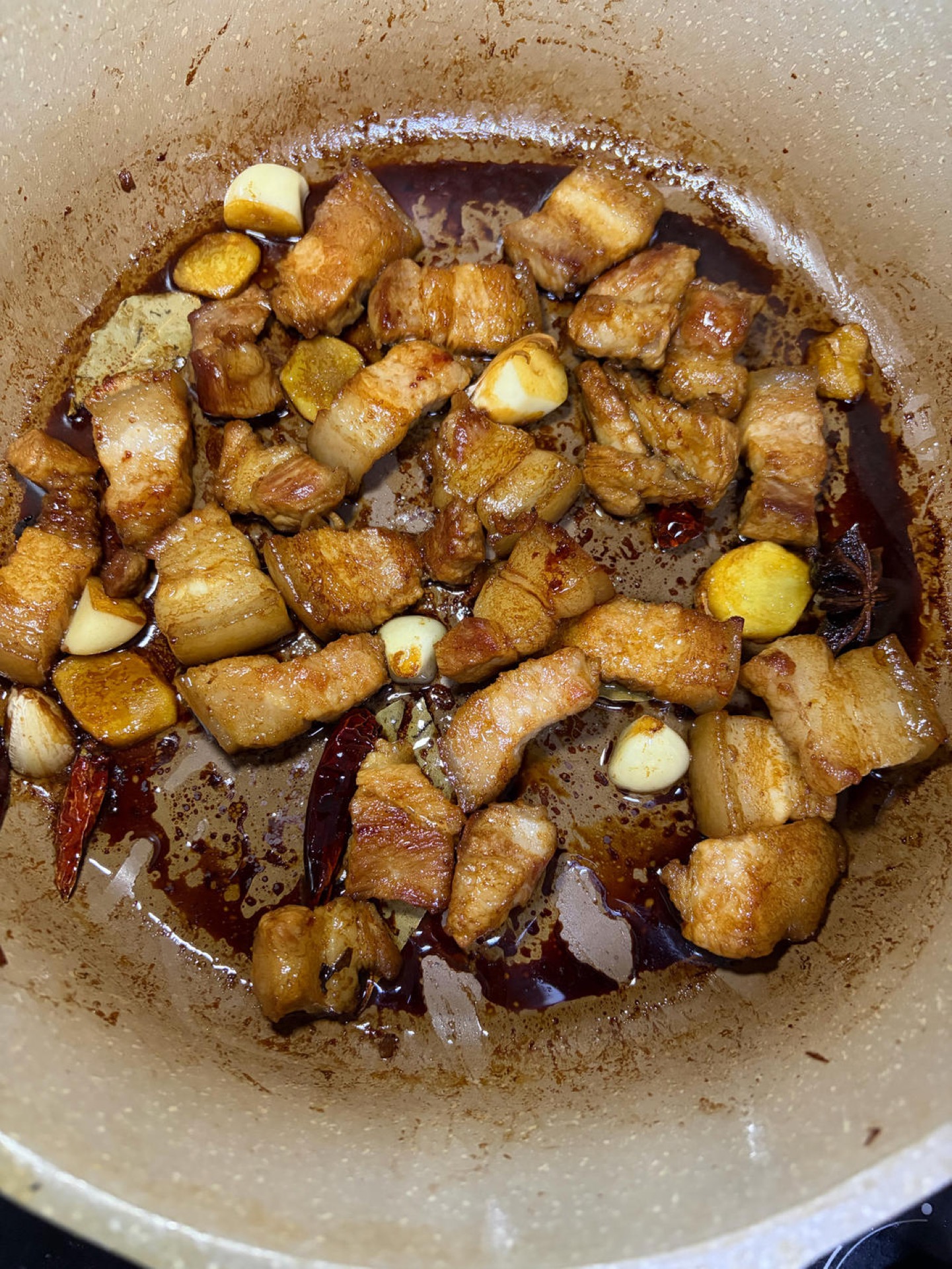 Pork belly coated in soy sauce in the wok