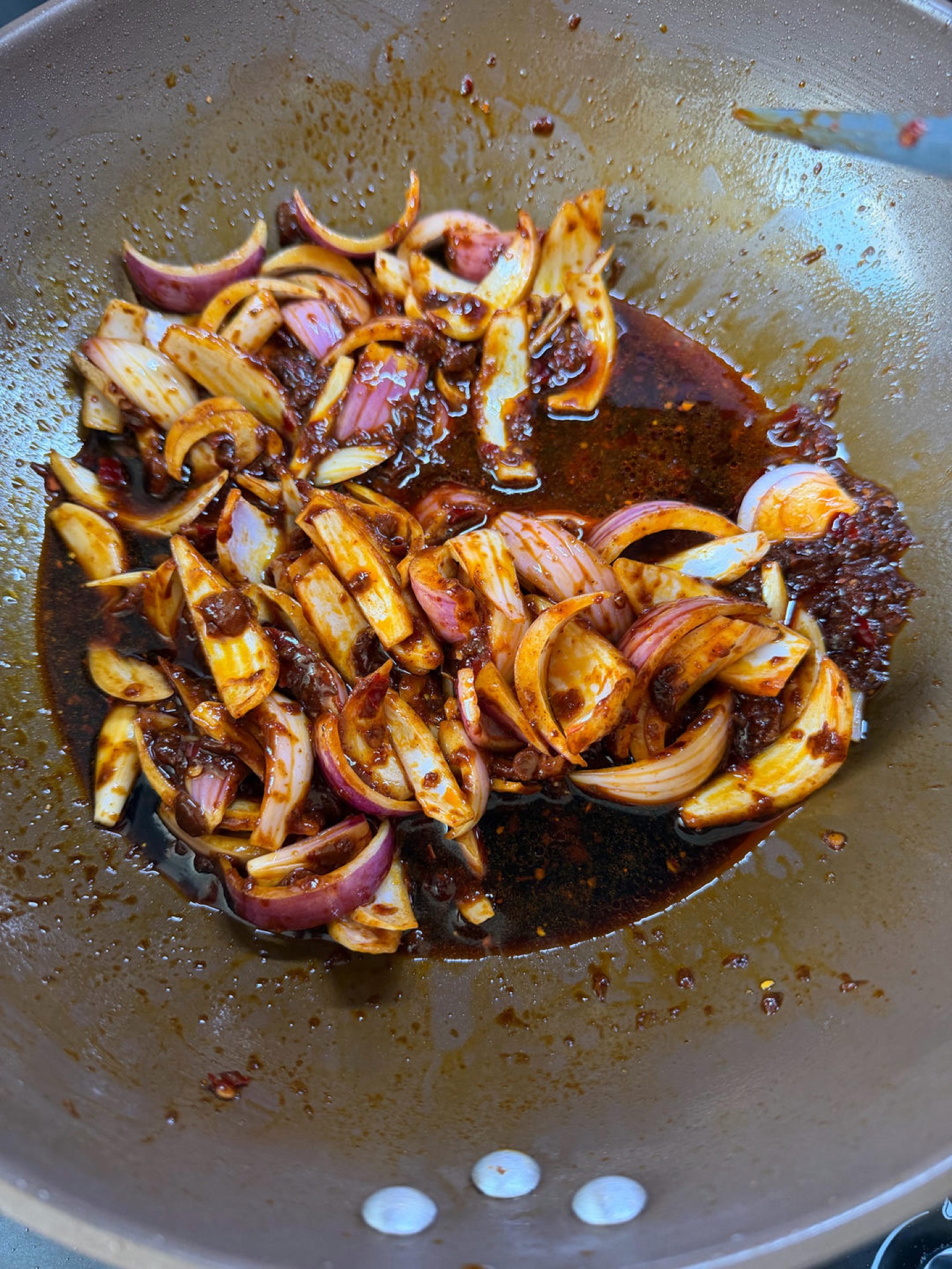 Aromatic sauce base spread evenly across the bottom of a heavy pot