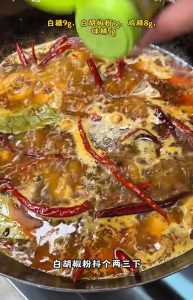 Adding water and seasonings to the wok