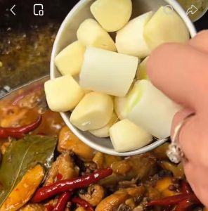 Reducing the sauce and adding scallions and garlic