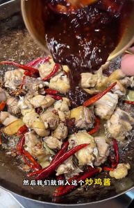 Stir-frying the sauce with the chicken