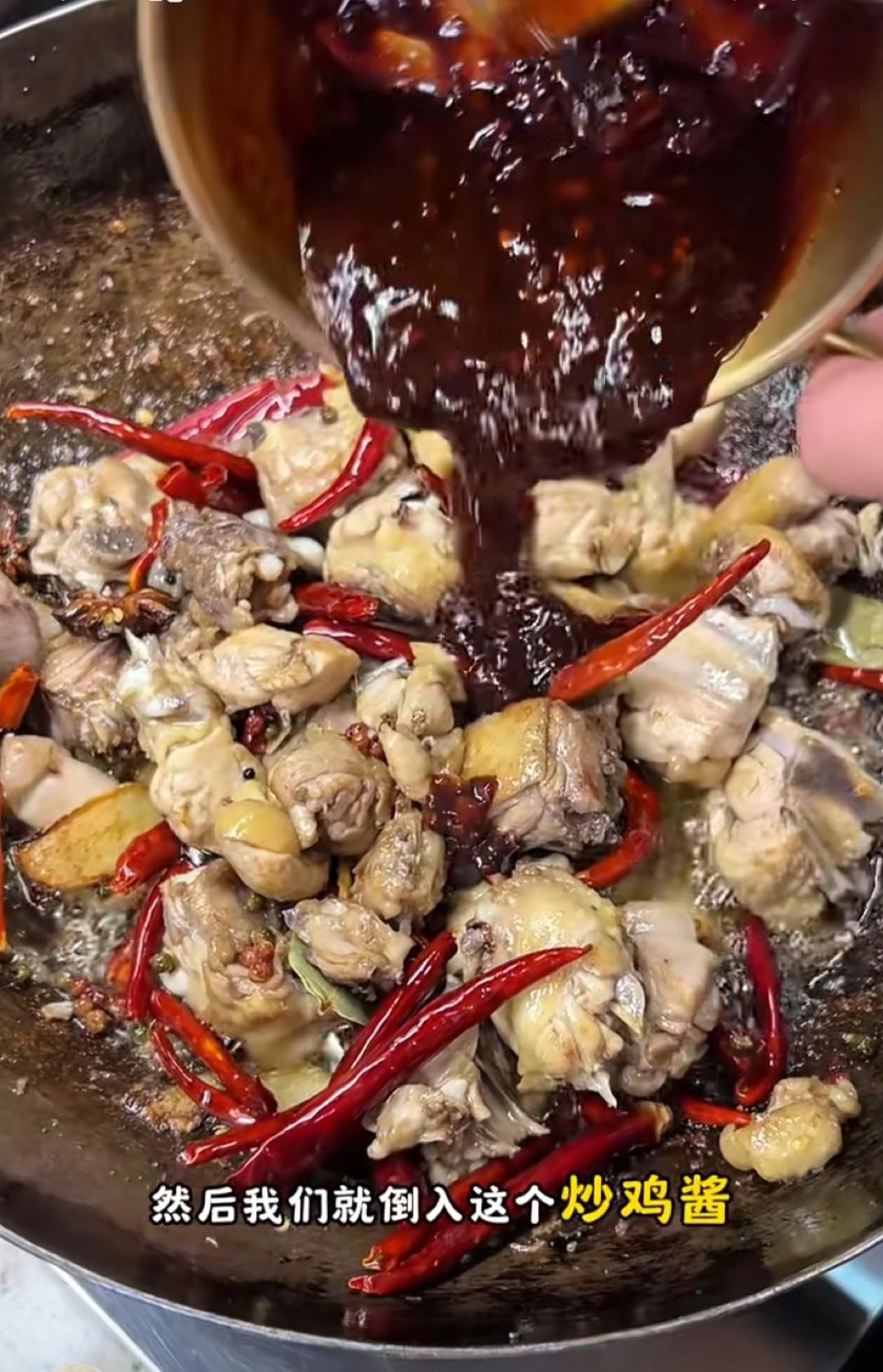 Stir-frying the sauce with the chicken