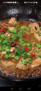 Scatter over the sliced fresh chilies and sliced scallions.