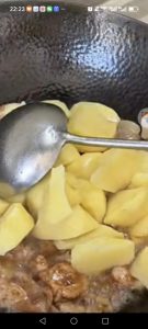 Add the potato chunks to the wok.