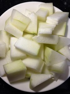 Peel the winter melon, scoop out the seeds and spongy center, and cut the flesh into large, even cubes.