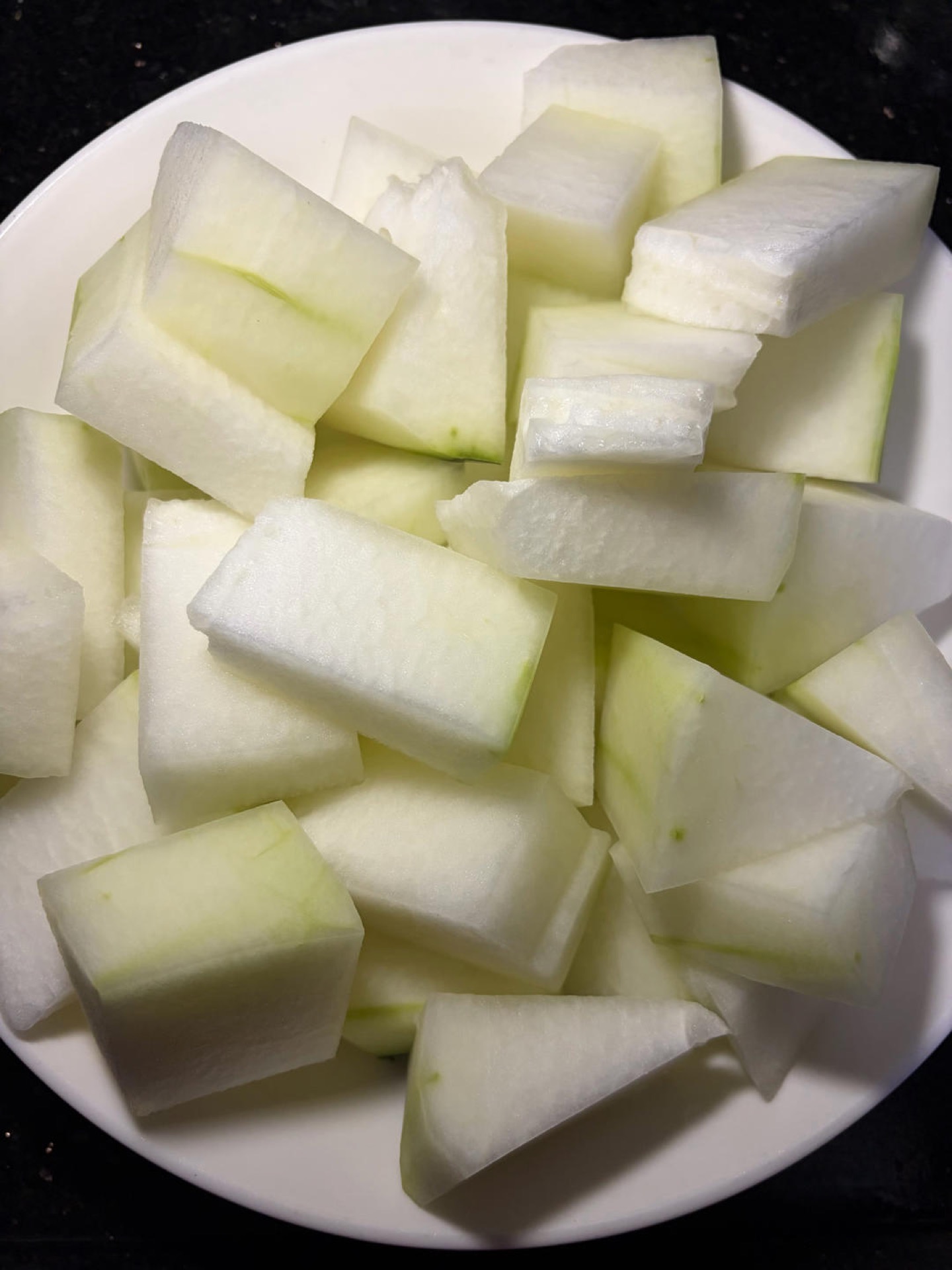 Peel the winter melon, scoop out the seeds and spongy center, and cut the flesh into large, even cubes.