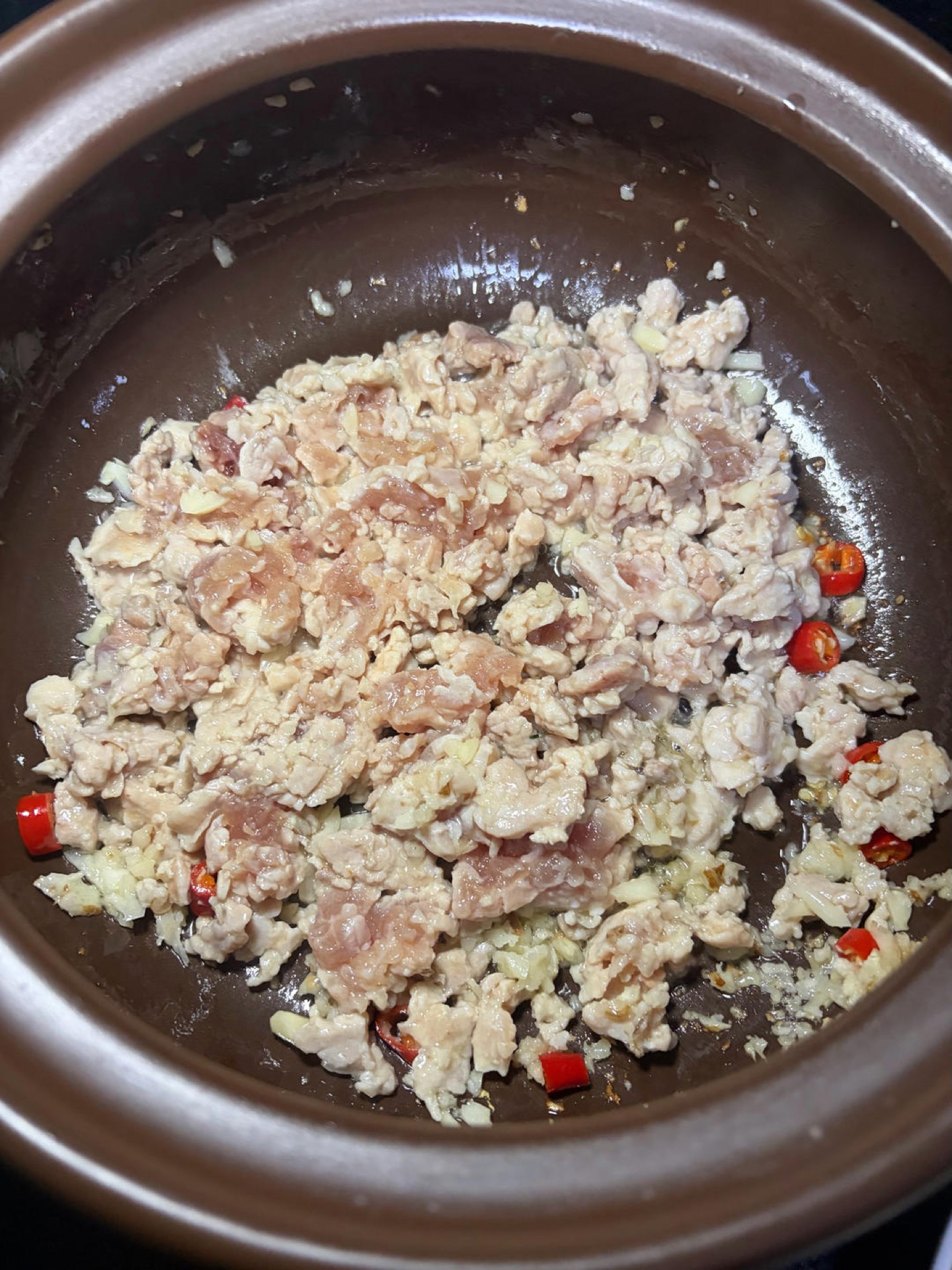Add the minced pork and stir-fry over medium-low heat until the surface turns lightly golden.