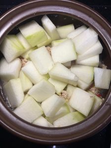 Add the winter melon cubes and pour in about half a bowl of water, no more, because the melon will release its own liquid.