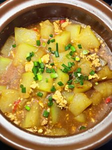 Scatter the sliced scallion over the top and serve straight from the pot.