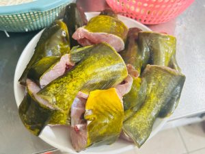 Yellow catfish cut into chunks on a board