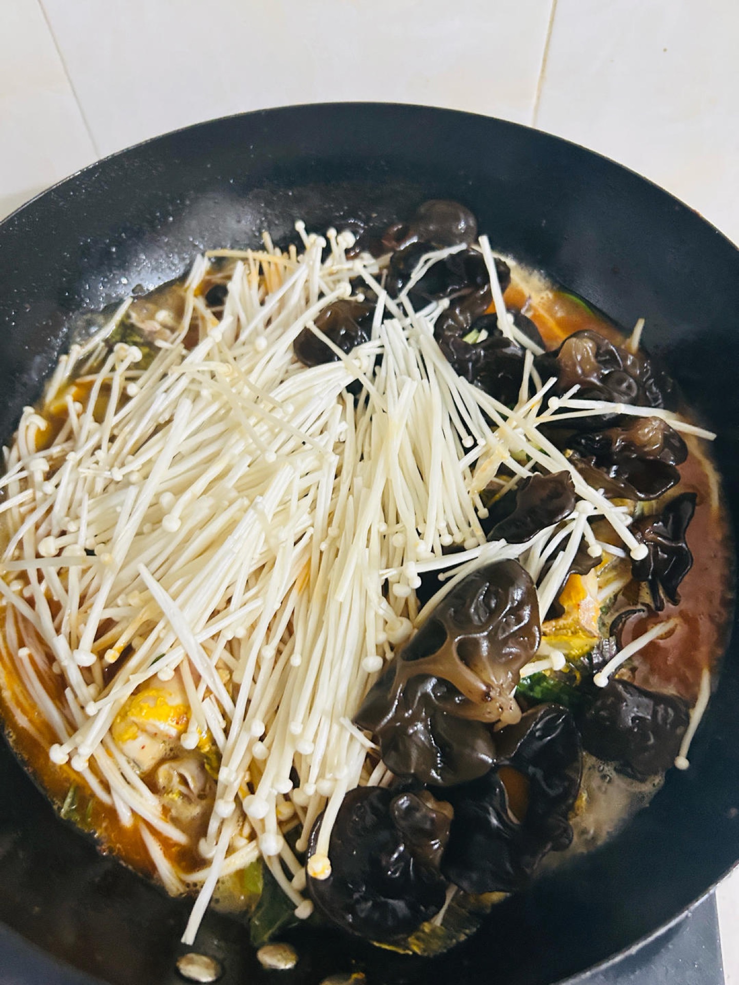 Vegetables and aromatics added to the covered pan