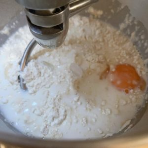 Mixing the bread dough until a rough membrane forms