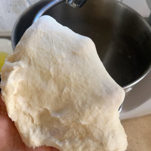 Adding softened butter and salt to the dough