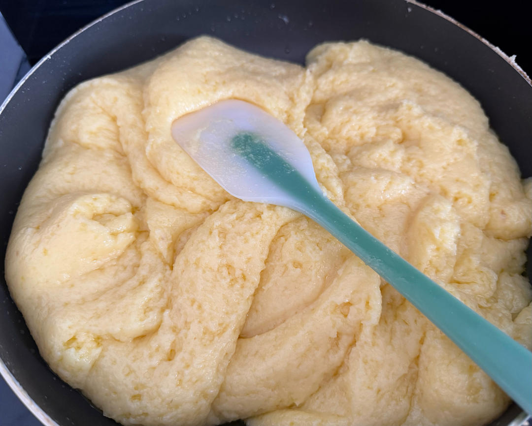 Cream cheese filling being mixed and sifted