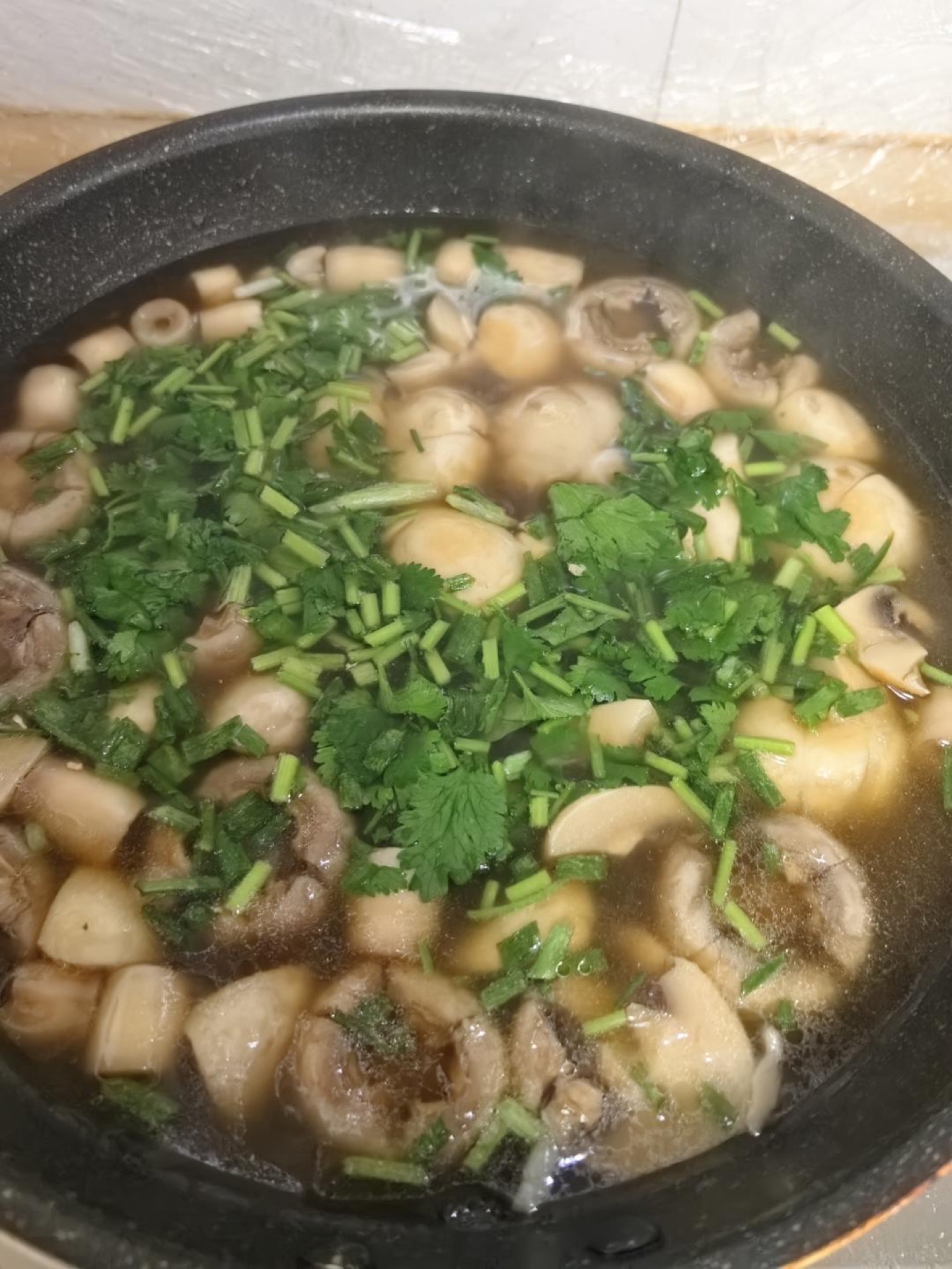 Add the cilantro and scallions, then take the soup off the heat and serve.