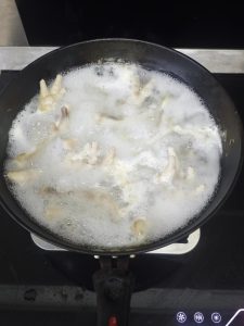 A layer of foam will rise during cooking and must be skimmed off — it is mostly blood and impurities, and if you leave it the feet will carry a gamy smell that ruins the hot and so