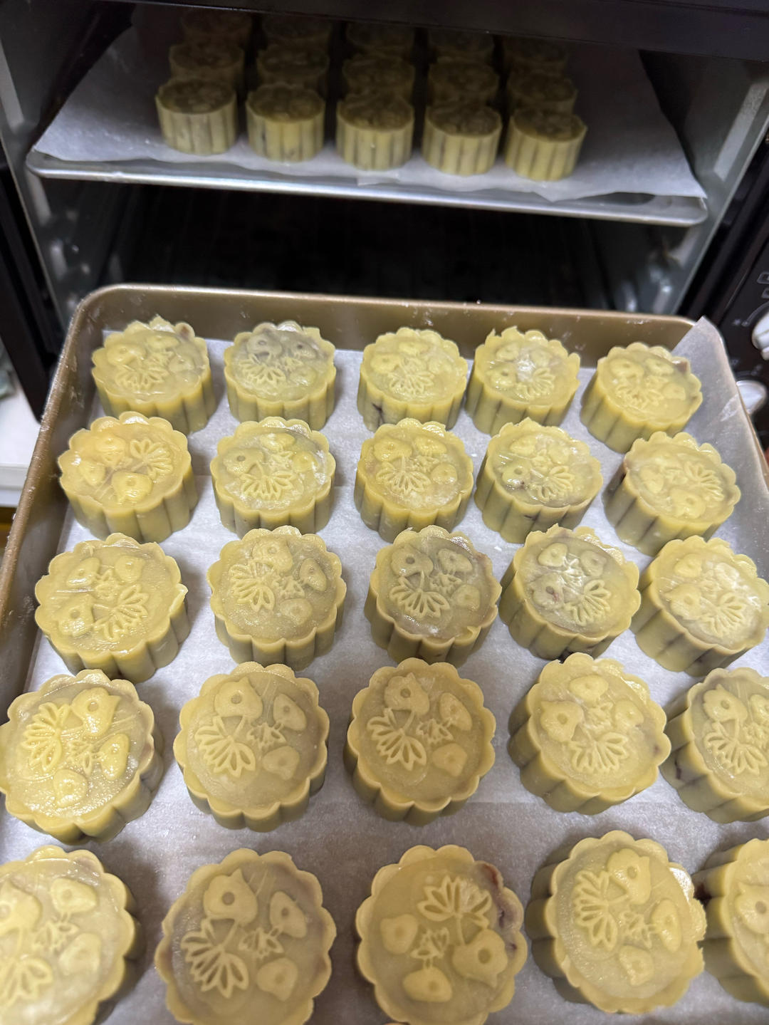 Mooncakes being sprayed with water before baking
