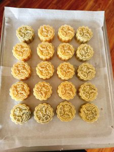 Mooncake being pressed in a carved mold