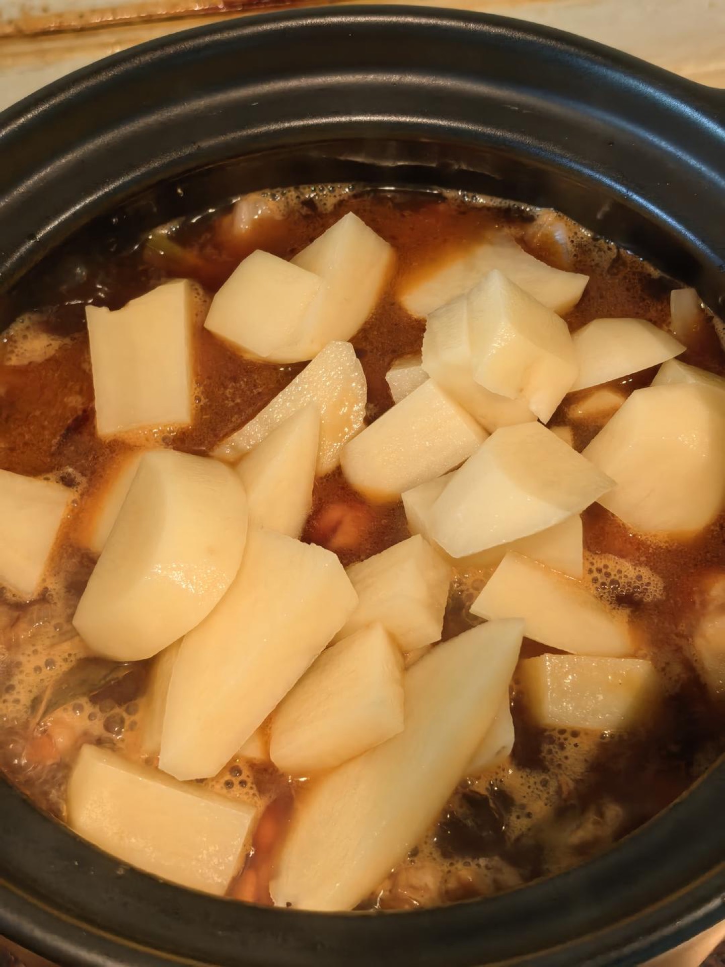 Potatoes added to the simmering stew